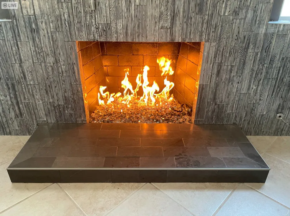 Stacked stone-look tile fireplace with raised hearth