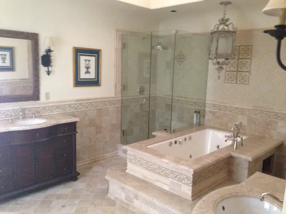Master bathroom remodel with travertine tile, glass shower and tub surround