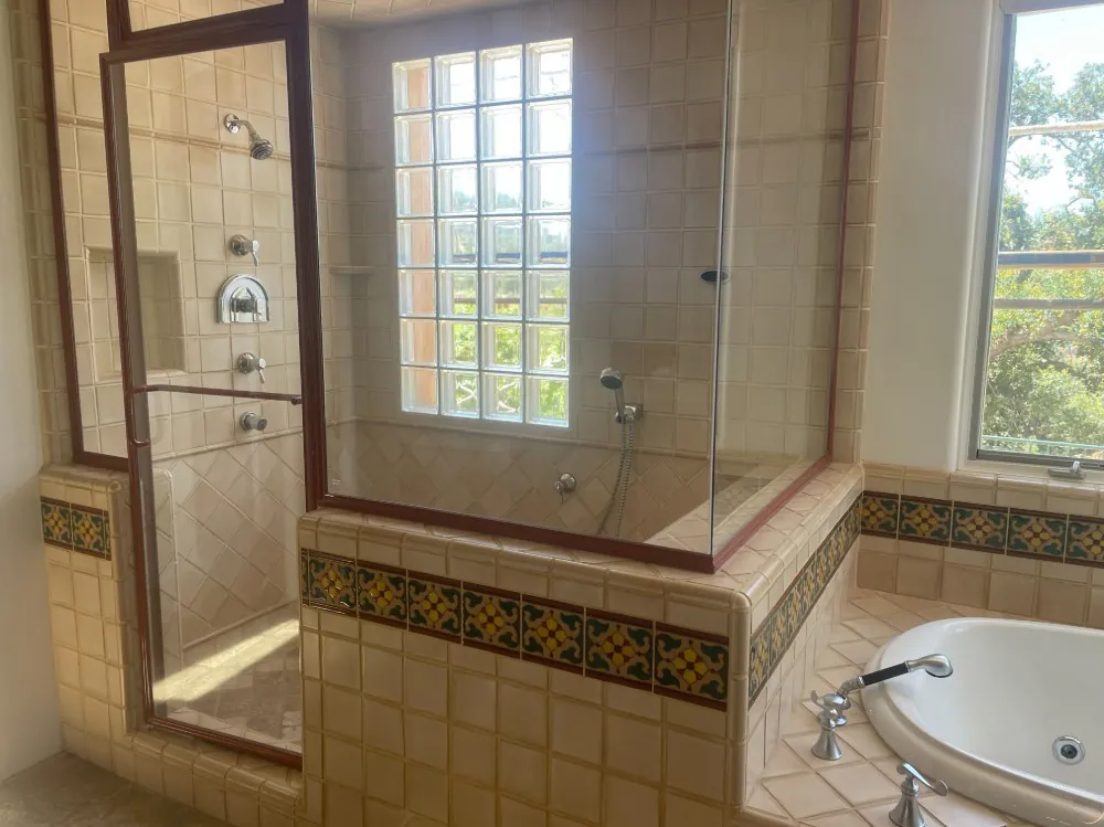 Travertine shower and tub with decorative tile border