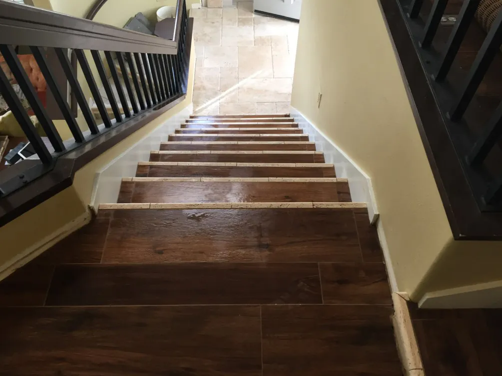 Staircase finished with wood-look plank flooring